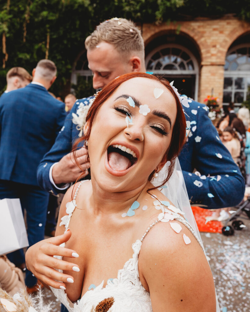candid photo of a bride having fun on her wedding day, by candid wedding photographer in Yorkshire