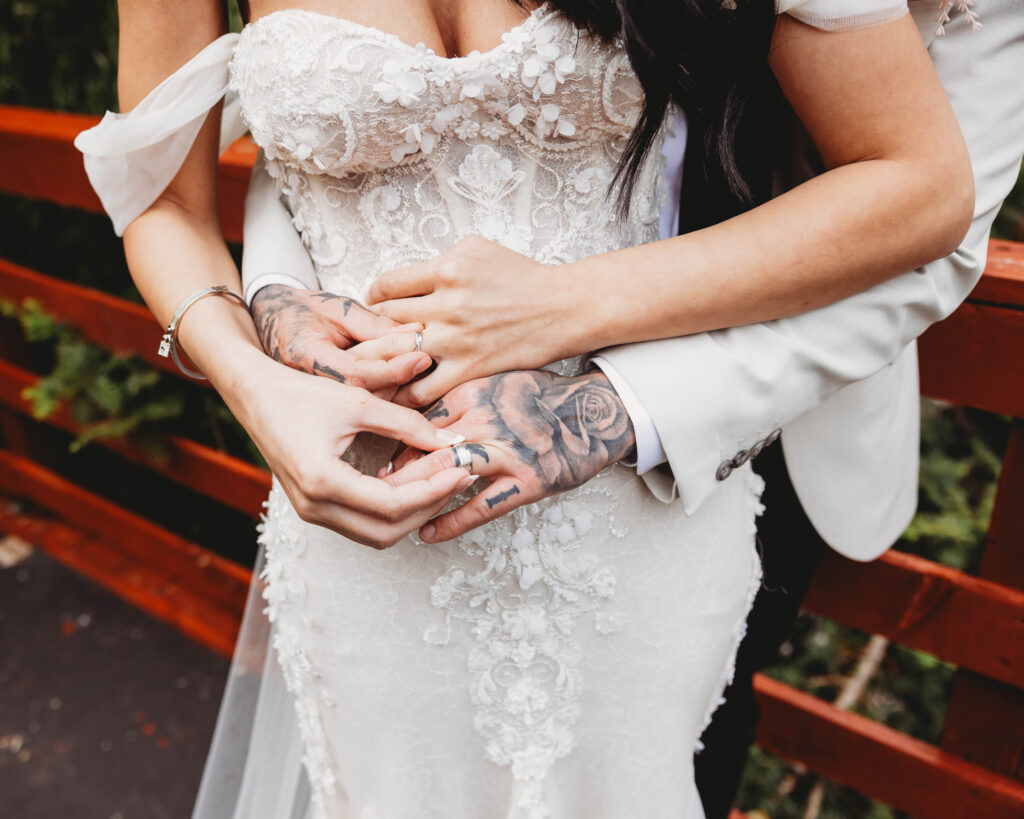 bride and groom showing off their rings in a blog post about how to propose at Christmas