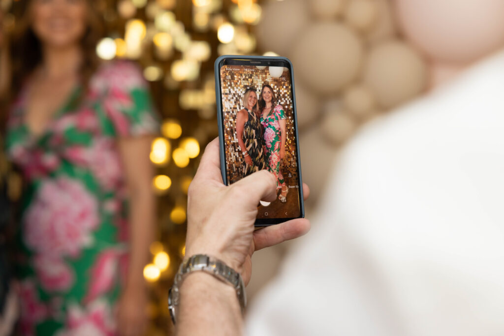 A guest taking photos at a wedding when they know how to propose at Christmas