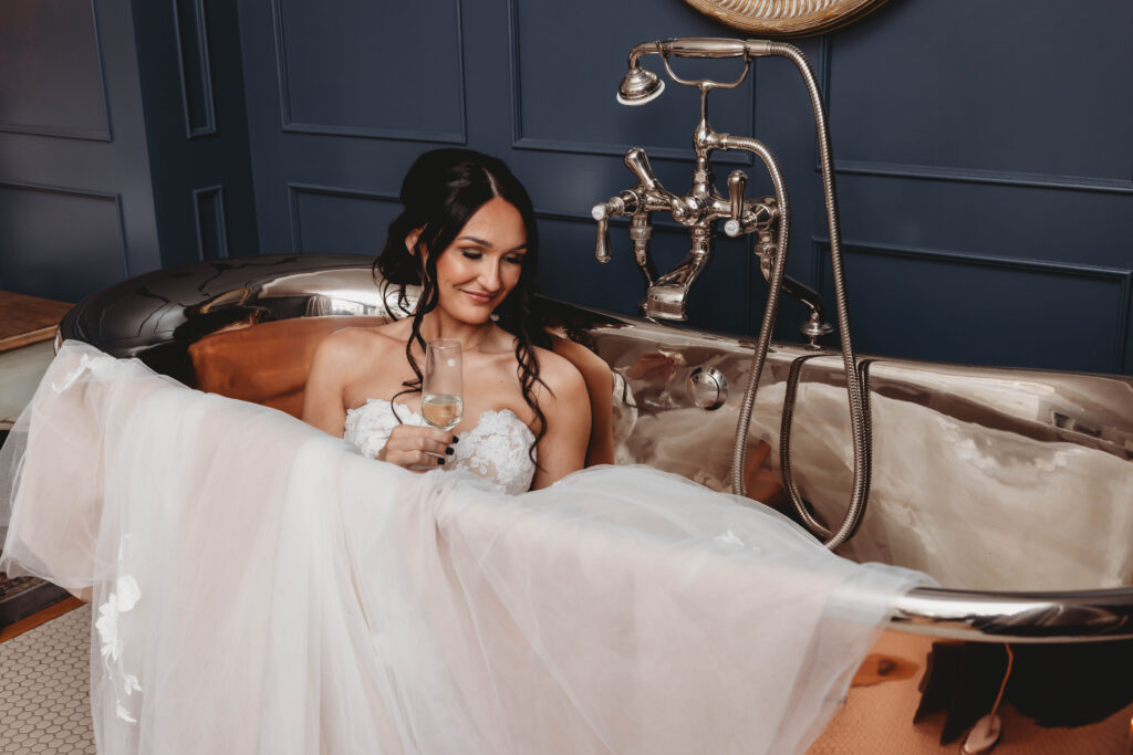bride in a copper bath in her dress after planning a wedding in Hull